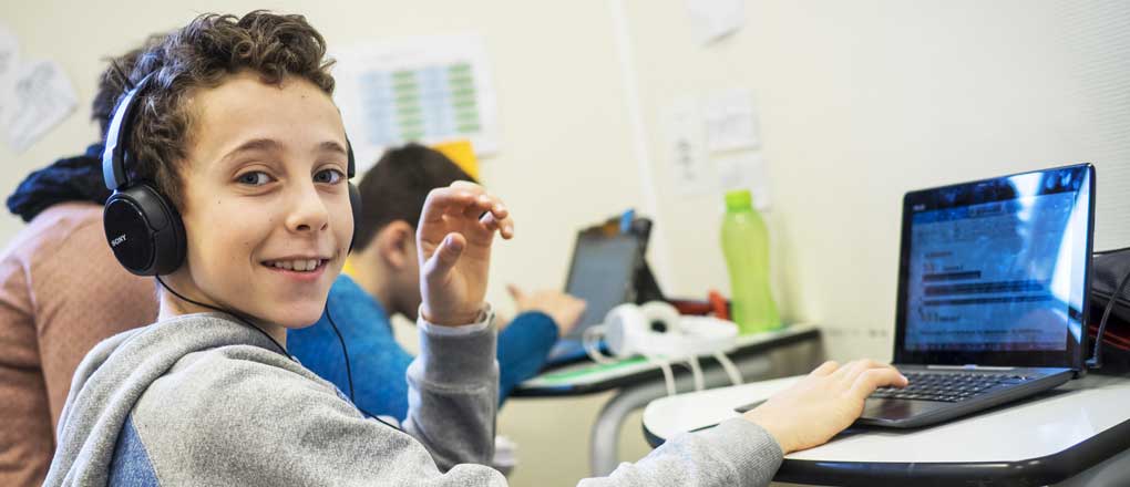 Enfant d'école utilisant un ordinateur portable. École enfant de 7